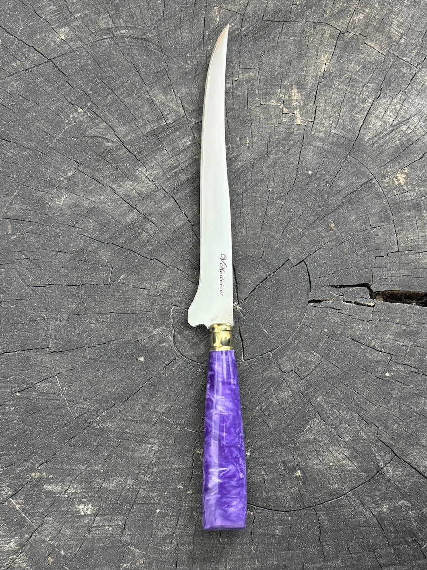 Knife with a purple handle on a gray surface